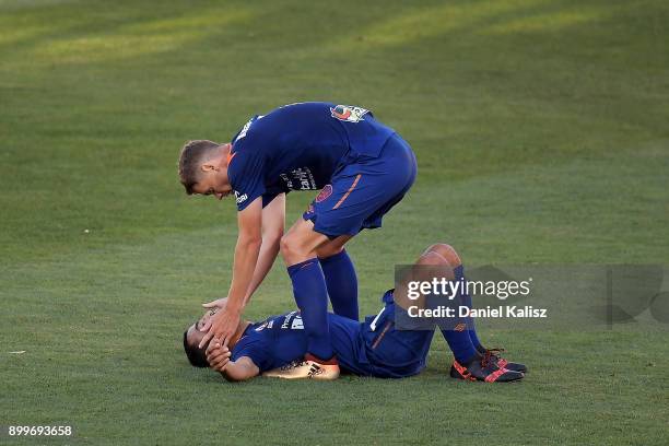 Fahid Ben Khalfallah and Thomas Kristensen of the Roar celebrate after the the round 13 A-League match between Adelaide United and Brisbane Roar at...