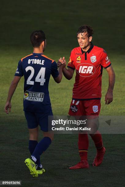 Connor O'Toole of the Roar ad Nikola Mileusnic of United shake hands after the the round 13 A-League match between Adelaide United and Brisbane Roar...