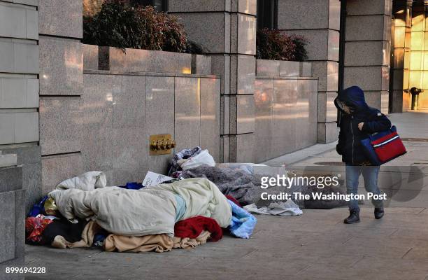Group of homeless folks catches the eye of a pedestrian on the 1300 block of K street NW. One of the sleepers is Dion Druz who opts for the streets...