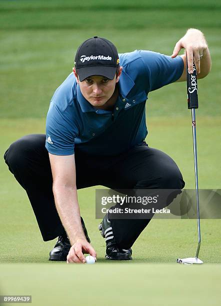 Justin Rose of England lines up a putt during the first round of the Wyndham Championship at Sedgefield Country Club on August 20, 2009 in...