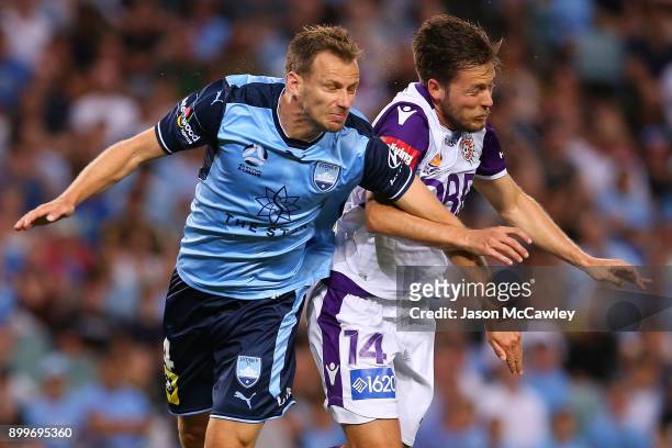Alex Wilkinson of Sydney is challenged by Chris Harold of the Glory during the round 13 A-League match between Sydney FC and Perth Glory at Allianz...