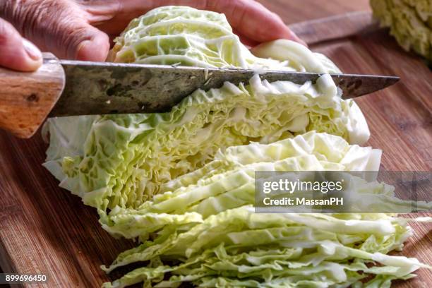 cabbage being sliced with old knife - cappuccio stock pictures, royalty-free photos & images