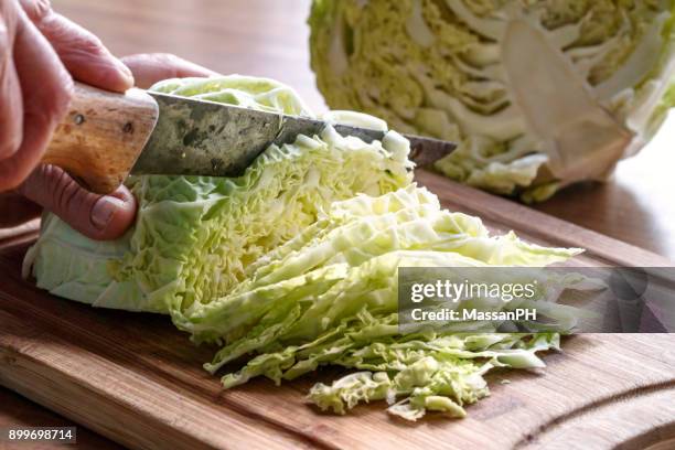 cabbage being sliced with old knife - cabbage stock-fotos und bilder