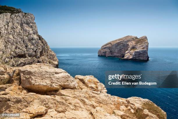 capo caccia cliffs and a small island in the mediterranean sea - alghero stock pictures, royalty-free photos & images