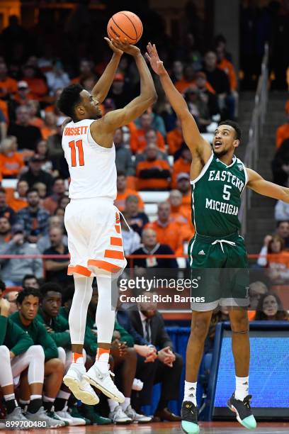 Oshae Brissett of the Syracuse Orange shoots the ball against the defense of Elijah Minnie of the Eastern Michigan Eagles during the first half at...