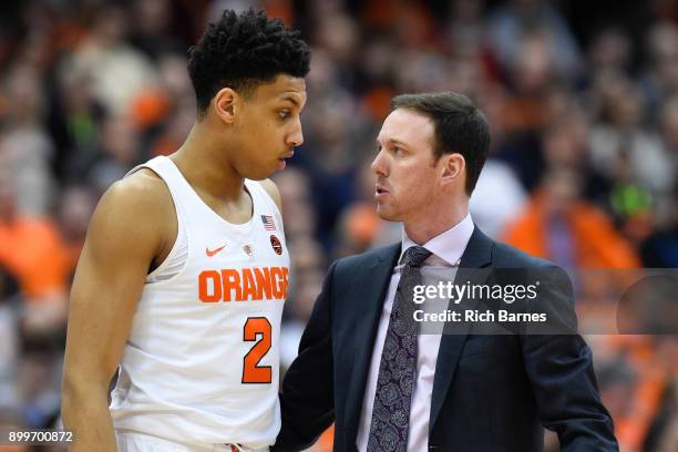 Matthew Moyer talks with assistant coach Gerry McNamara of the Syracuse Orange during a time-out against the Eastern Michigan Eagles during the...