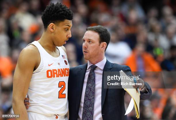 Matthew Moyer talks with assistant coach Gerry McNamara of the Syracuse Orange during a time-out against the Eastern Michigan Eagles during the...