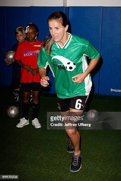 Soccer player Brandi Chastain teaches children about soccer and flu vaccinations at Super Soccer Stars Indoor Soccer Field on August 20, 2009 in New...
