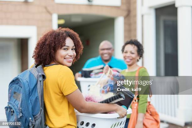 african-american parents helping daughter move - college dorm stock pictures, royalty-free photos & images