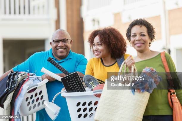african-american parents helping daughter move - basket universitario imagens e fotografias de stock