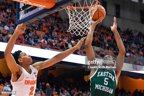 Elijah Minnie of the Eastern Michigan Eagles shoots the ball as Matthew Moyer of the Syracuse Orange defends during the first half at the Carrier...