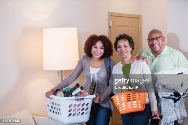 young woman with parents helping her move into apartment - basket universitario imagens e fotografias de stock