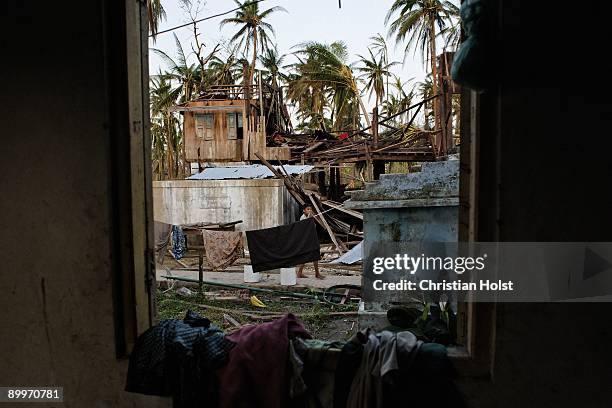 Villager walks past destroyed houses in the village of Nauk Pyan Doe on May 9, 2008 one hour south of Pyapon, Myanmar. On May 2, 2008 Myanmar was hit...