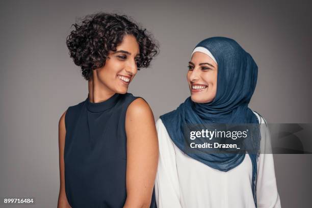 portrait of two beautiful women from middle east who live and work in australia - middle eastern people stock pictures, royalty-free photos & images
