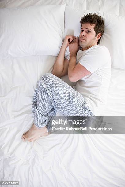man in bed - above view of man sleeping on bed stock pictures, royalty-free photos & images