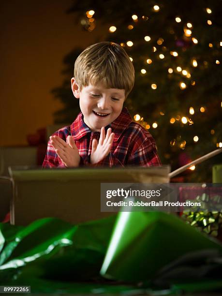 boy at christmas - boy opening present stock pictures, royalty-free photos & images