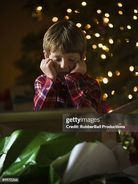 boy at christmas - disappointment gift stock pictures, royalty-free photos & images