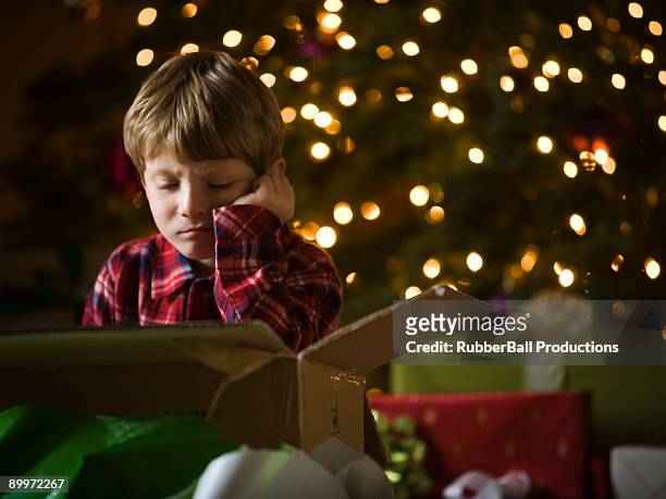 boy at christmas - disappointment gift stock pictures, royalty-free photos & images