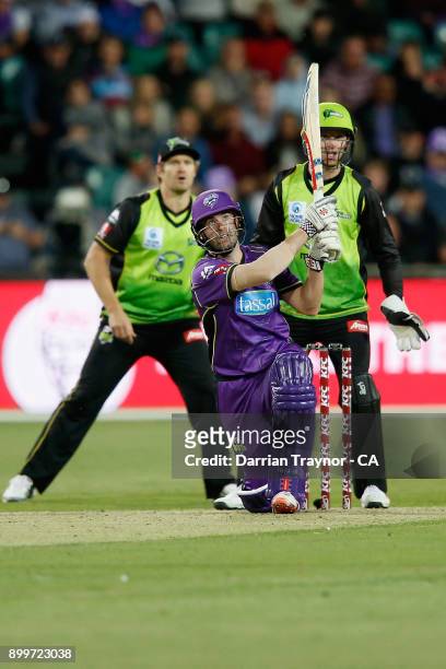 Alex Doolan of the Hobart Huuicanes hits the ball only to be caught in the outfield during the Big Bash League match between the Hobart Hurricanes...