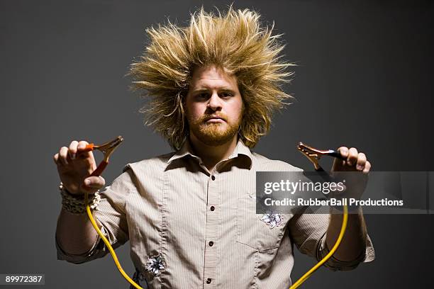 man with crazy hair holding jumper cables - hair standing on end stock pictures, royalty-free photos & images