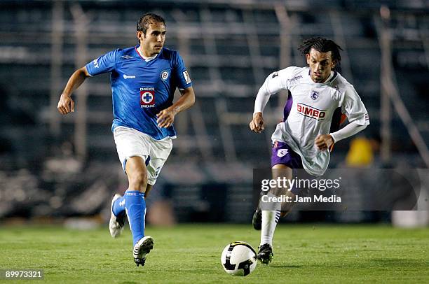 Alejandro Castro of Mexico's Cruz Azul carries the ball followed by Michael Barrantes of Costa Rica's Saprissa during their match for the Concacaf...