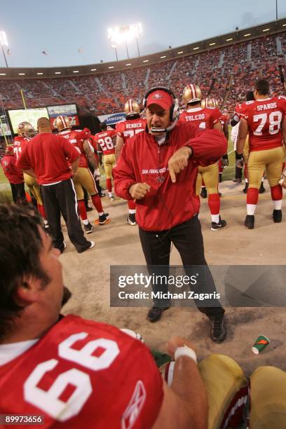 Chris Foerster meets with the offensive line of the San Francisco 49ers during a preseason game against the Denver Broncos on August 14, 2009 at...