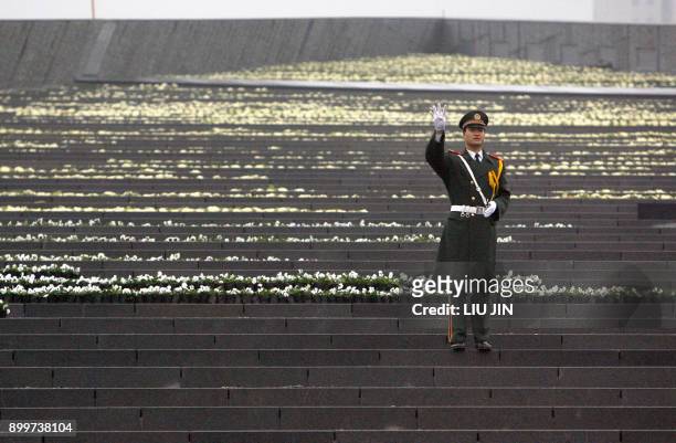 Chinese paramilitary soldier gestures to his fellow comrades as they place wreaths during a rehearsal ceremony for the 70th anniversary of the...