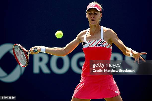 Elena Dementieva of Russia returns a shot to Shahar Peer of Israel during the Rogers Cup at the Rexall Center on August 20, in Toronto, Ontario,...