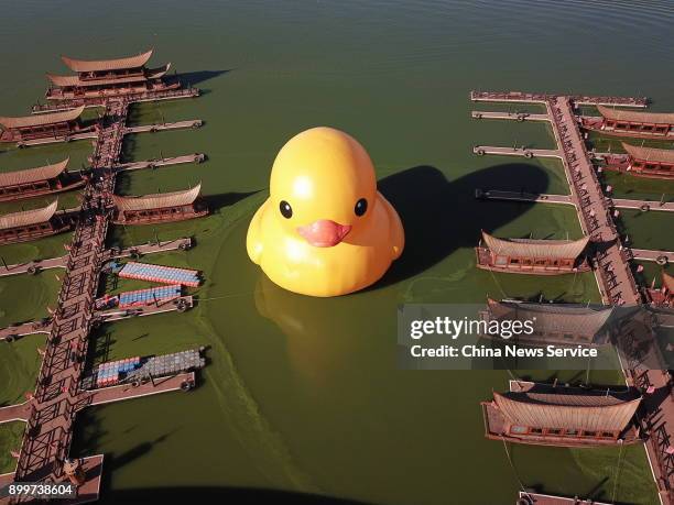 An 18-meter high rubber duck designed by Dutch conceptual artist Florentijn Hofman is on display at the Dianchi Lake on December 29, 2017 in Kunming,...