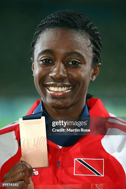 Josanne Lucas of Trinidad and Tobago receives the bronze medal during the medal ceremony for the women's 400 Metres Hurdles Final during day six of...