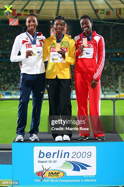 Lashinda Demus of United States receives the silver medal, Melaine Walker of Jamaica the gold medal and Josanne Lucas of Trinidad and Tobago the...