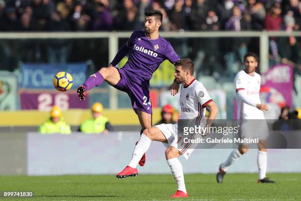 Marco Benassi of ACF Fiorentina fights for the ball with Fabio Borini of AC Milan during the serie A match between ACF Fiorentina and AC Milan at...