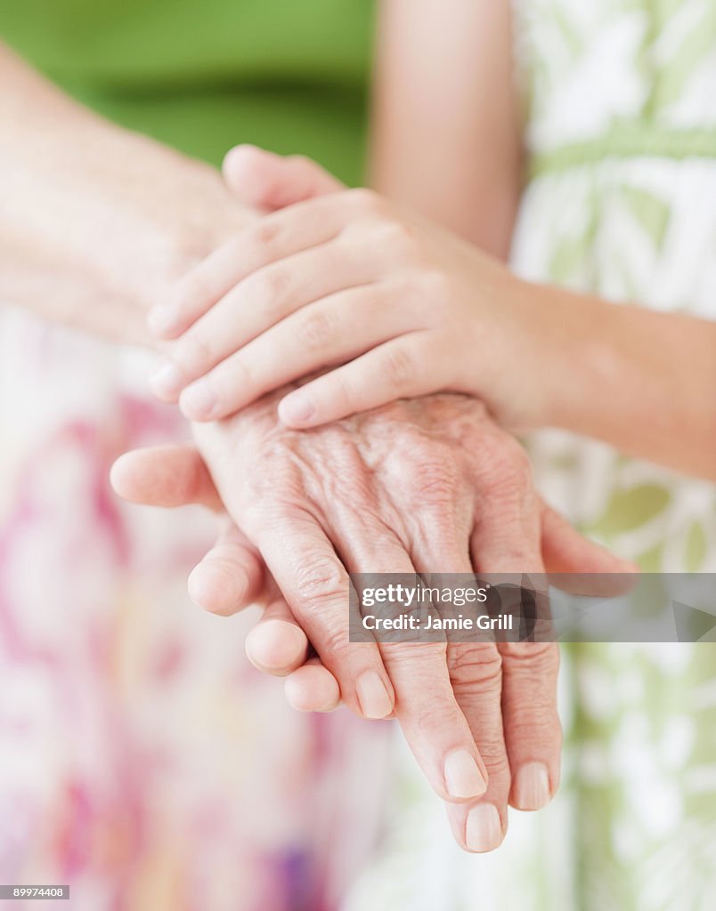 Grandmother and granddaugter's hands, close up