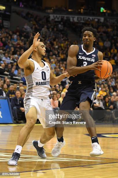 Quentin Goodin of the Xavier Musketeers works against Markus Howard of the Marquette Golden Eagles during a game at the BMO Harris Bradley Center on...