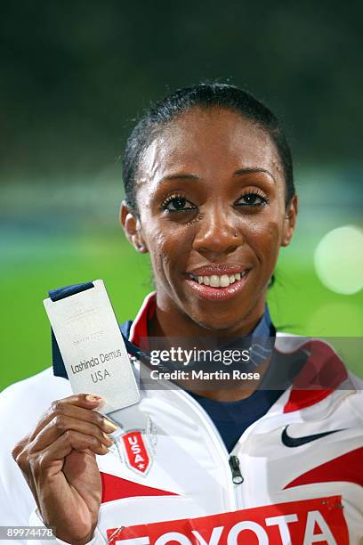 Lashinda Demus of United States receives the silver medal during the medal ceremony for the women's 400 Metres Hurdles Final during day six of the...