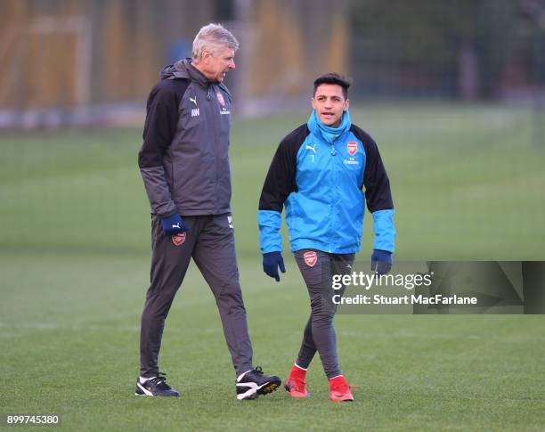 Arsenal manager Arsene Wenger talks to Alexis Sanchez before a training session at London Colney on December 30, 2017 in St Albans, England.