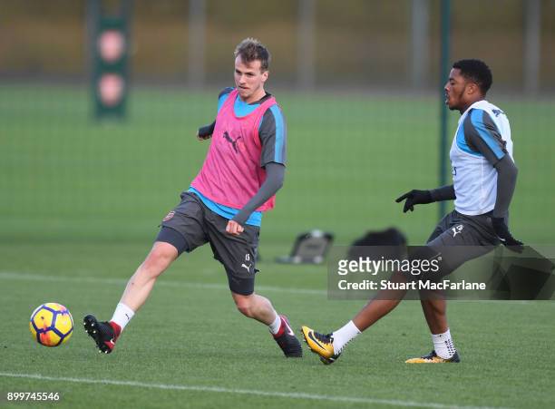 Chuba Akpom and Rob Holding of Arsenal during a training session at London Colney on December 30, 2017 in St Albans, England.