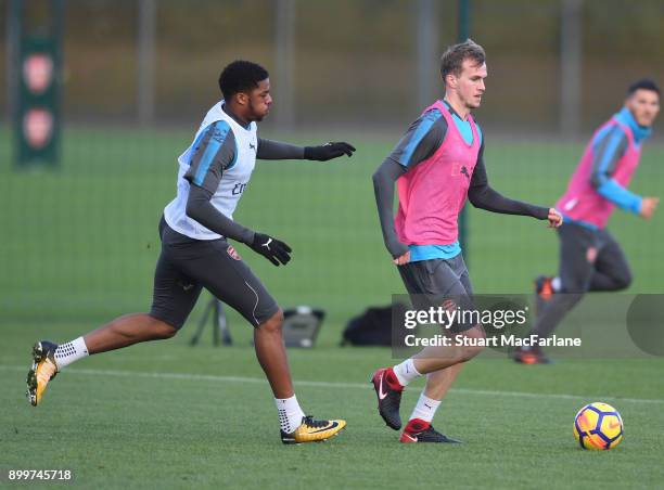 Chuba Akpom and Rob Holding of Arsenal during a training session at London Colney on December 30, 2017 in St Albans, England.