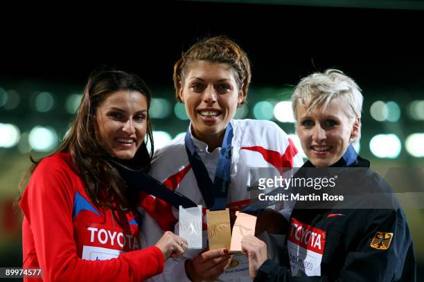Anna Chicherova of Russia receives the silver medal, Blanka Vlasic of Croatia the gold medal and Ariane Friedrich of Germany the bronze medal during...