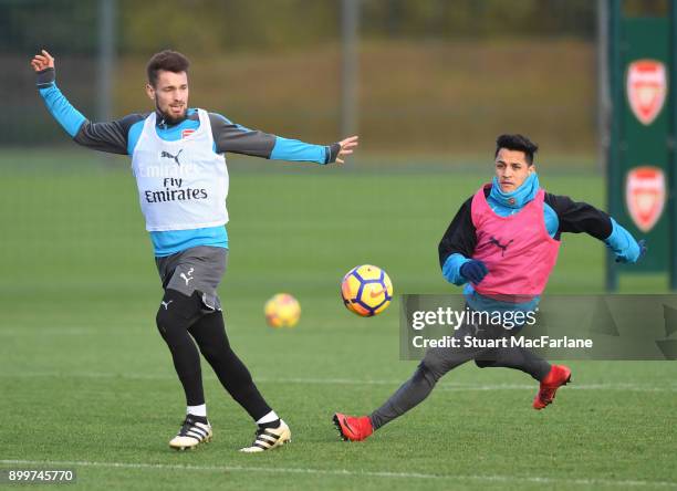 Mathieu Debuchy and Alexis Sanchez of Arsenal during a training session at London Colney on December 30, 2017 in St Albans, England.