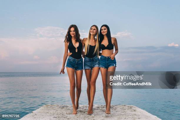 three beautiful girls on the beach - slim stock pictures, royalty-free photos & images