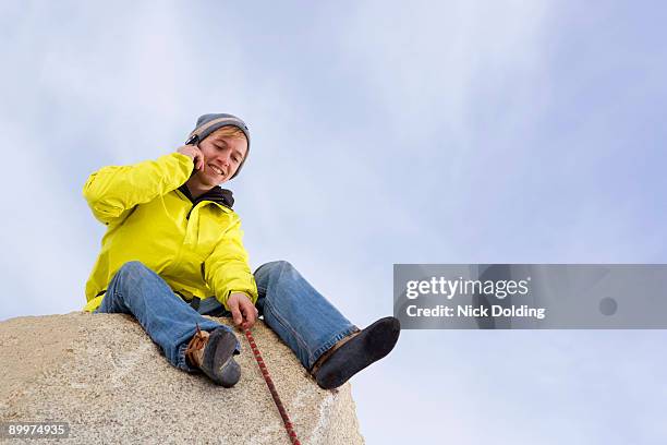 climber belaying fellow climber - messa in sicurezza foto e immagini stock