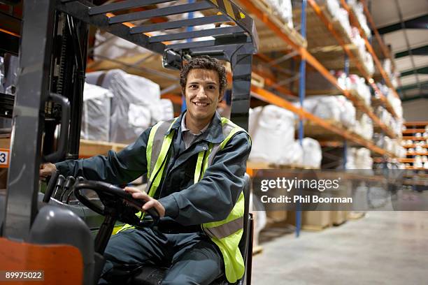 worker on forklift, smiling to camera - forklift safety stock pictures, royalty-free photos & images