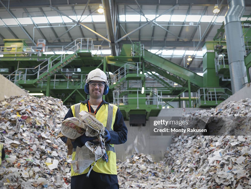 Worker With Paper Being Recycled
