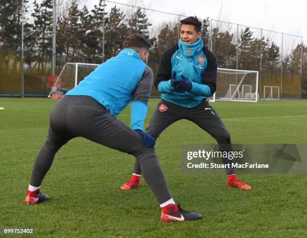 Shkodran Mustafi and Alexis Sanchez of Arsenal during a training session at London Colney on December 30, 2017 in St Albans, England.