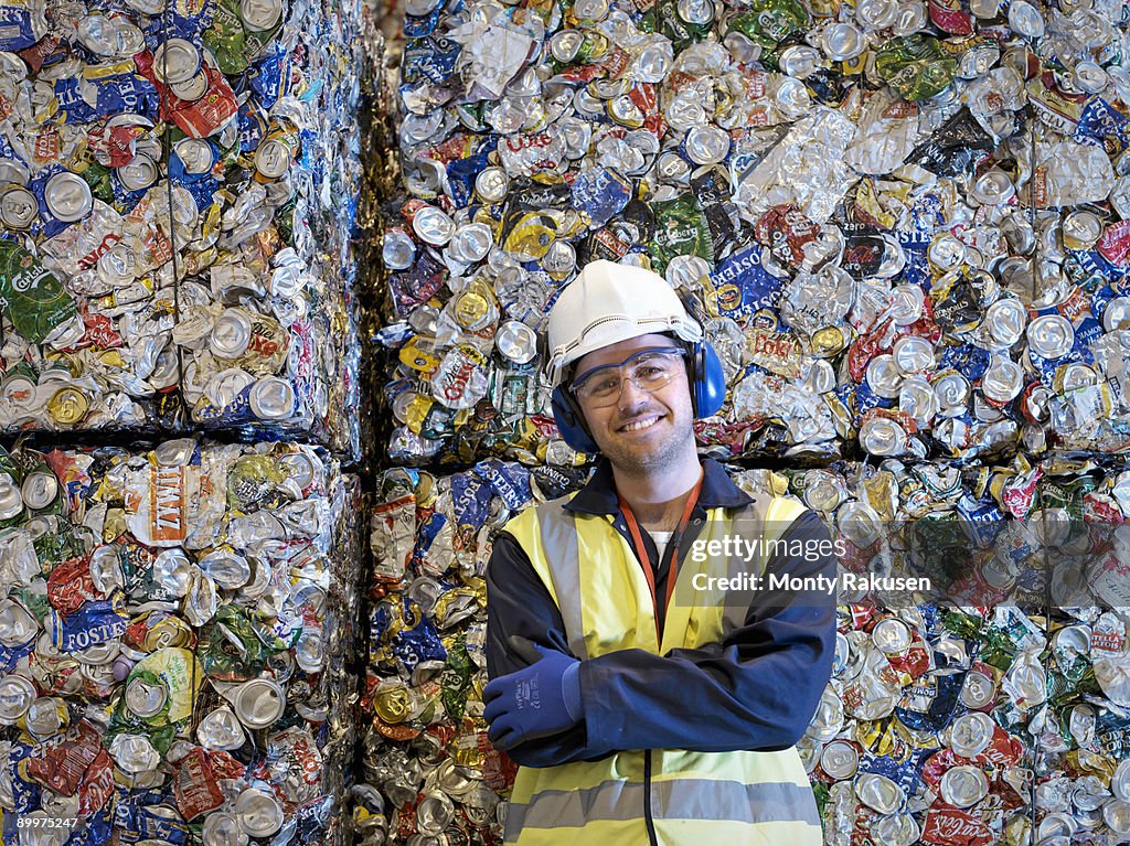Recycle Worker With Bales Of Tin Cans