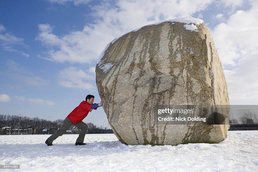 Man pushing boulder