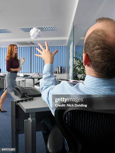 office worker throwing paper ball - paper ball stock-fotos und bilder