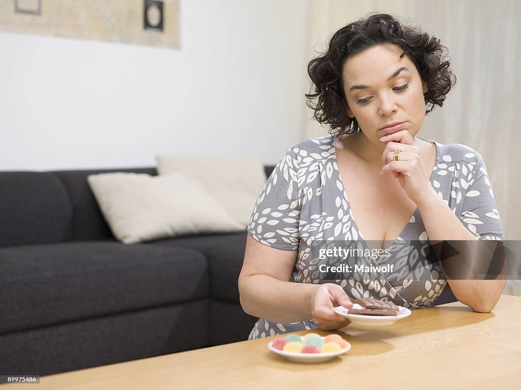 Woman comparing sweets.