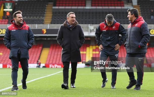 Second left, Carlos Carvalhal, Manager of Swansea City inspects the pitch with his assistants prior to the Premier League match between Watford and...